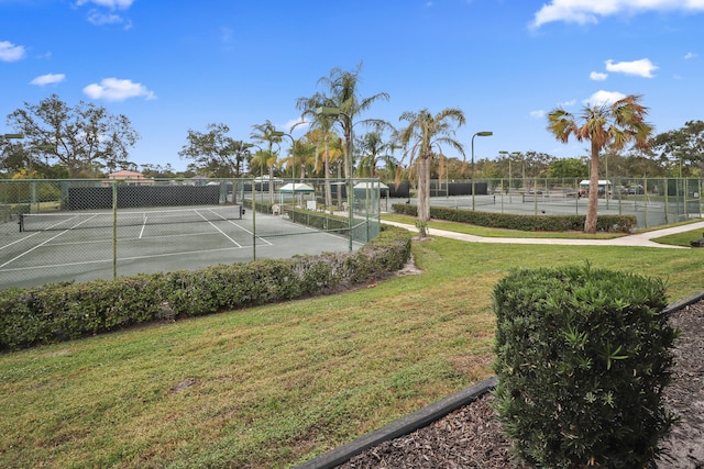 view of sport court featuring a yard