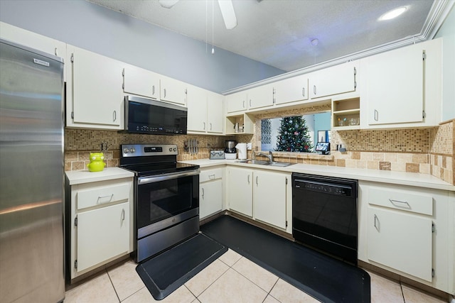 kitchen featuring white cabinets, light tile patterned floors, sink, and appliances with stainless steel finishes