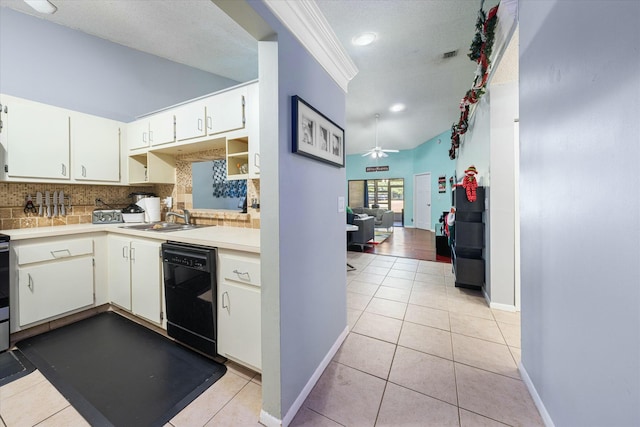 kitchen featuring backsplash, sink, ceiling fan, black dishwasher, and light tile patterned flooring