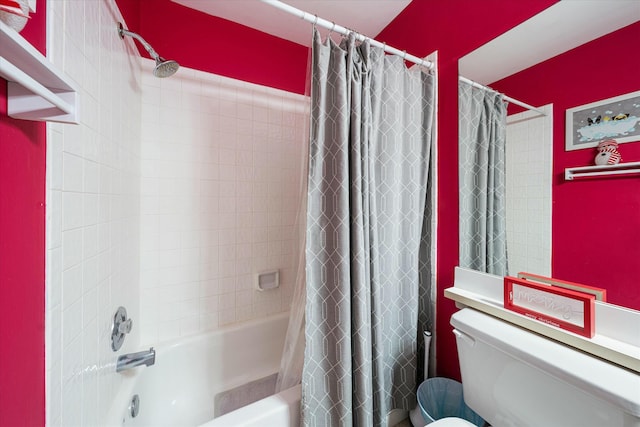 bathroom with toilet and shower / bath combo with shower curtain