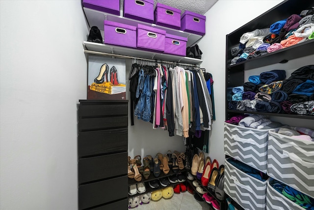 spacious closet with tile patterned floors