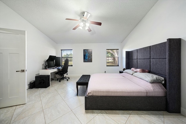 tiled bedroom featuring a textured ceiling, ceiling fan, and vaulted ceiling