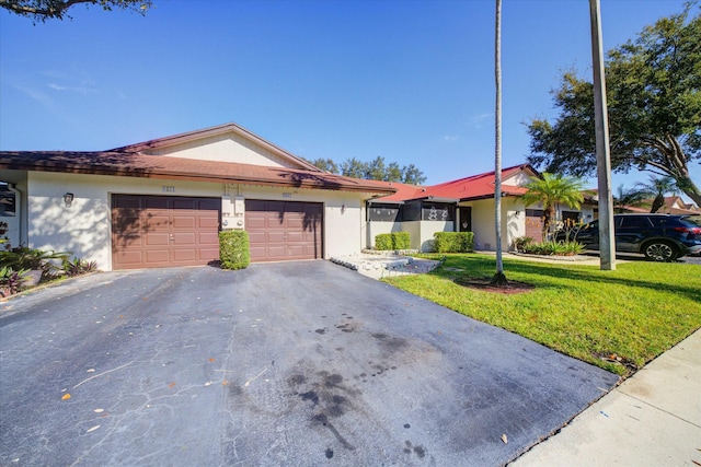 ranch-style home featuring a garage and a front lawn