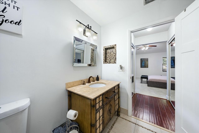 bathroom featuring tile patterned flooring, ceiling fan, toilet, and vanity