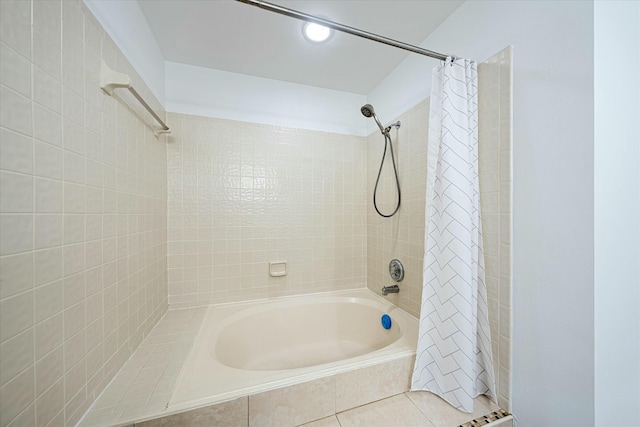 bathroom with tile patterned floors and shower / bath combo with shower curtain