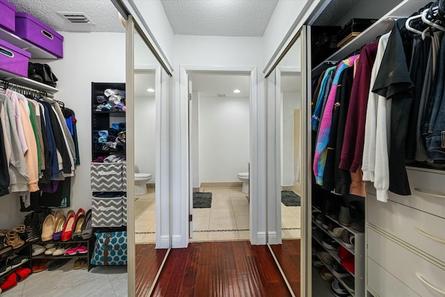 walk in closet featuring hardwood / wood-style floors