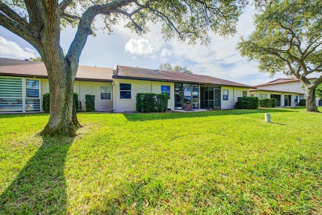 rear view of house with a lawn