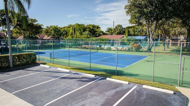 view of tennis court with basketball hoop