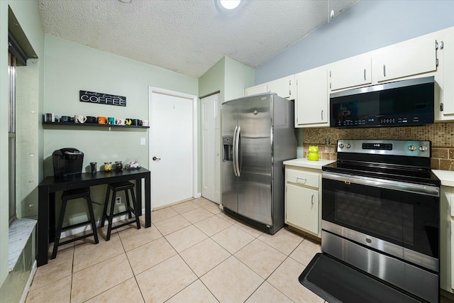 kitchen with white cabinetry, stainless steel appliances, tasteful backsplash, a textured ceiling, and light tile patterned floors