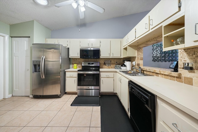 kitchen with decorative backsplash, appliances with stainless steel finishes, ceiling fan, light tile patterned floors, and lofted ceiling