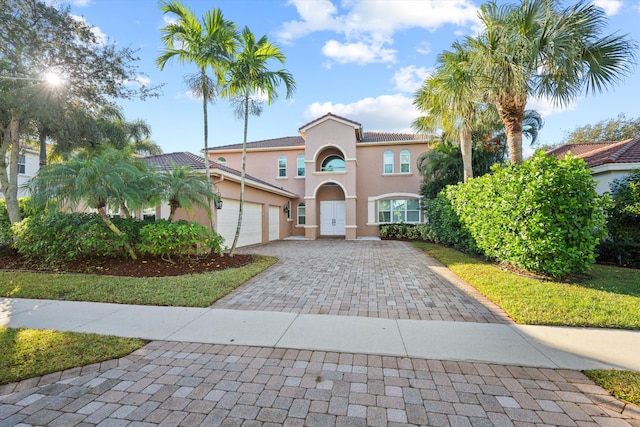 mediterranean / spanish house featuring a garage