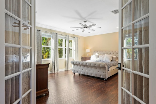 bedroom with crown molding, dark wood-type flooring, and french doors