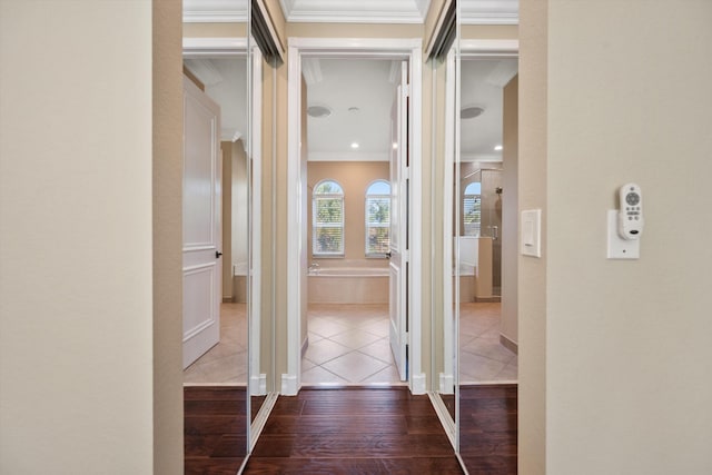 hallway with tile patterned flooring and crown molding