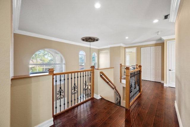 corridor with ornamental molding and dark hardwood / wood-style flooring