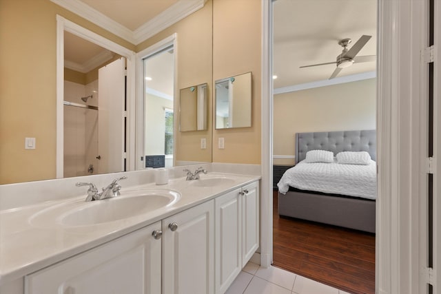 bathroom featuring walk in shower, tile patterned floors, ornamental molding, vanity, and ceiling fan