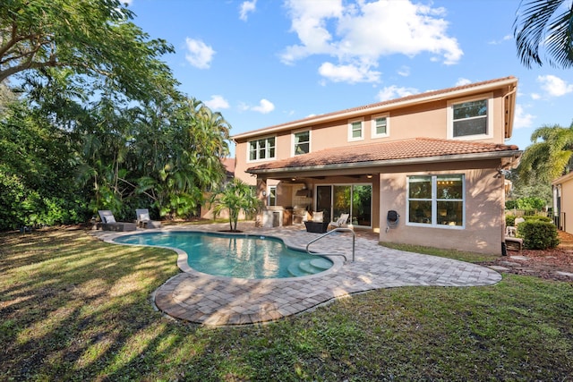 view of swimming pool with a yard and a patio area