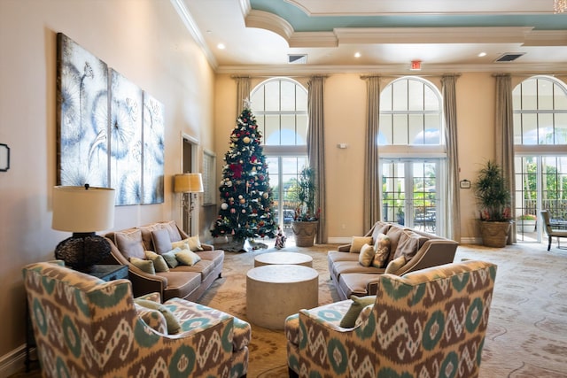 carpeted living room featuring crown molding, a towering ceiling, and french doors