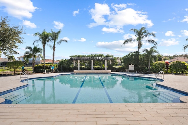 view of swimming pool with a patio area and a pergola