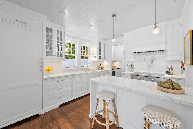 kitchen featuring white cabinets and hanging light fixtures