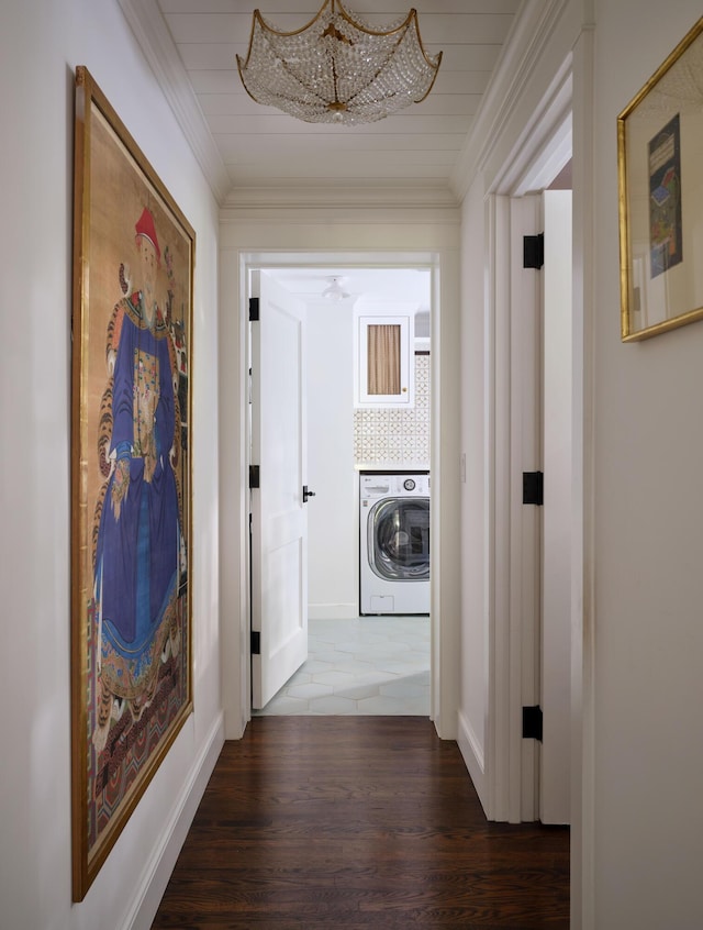 hall with dark hardwood / wood-style flooring, washer / clothes dryer, and ornamental molding