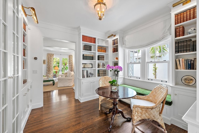 living area featuring dark hardwood / wood-style flooring, french doors, and ornamental molding