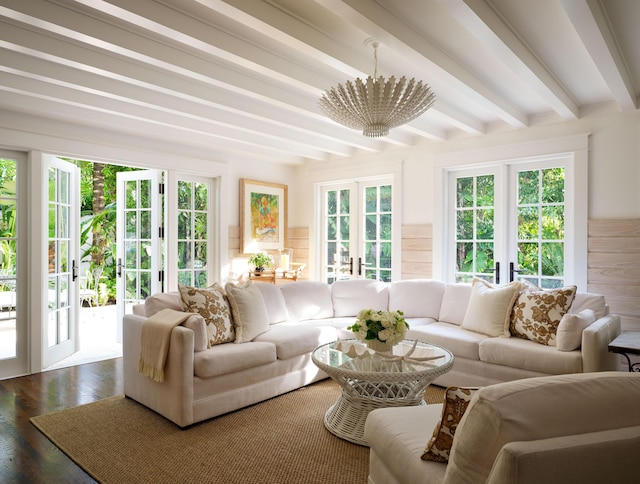 sunroom / solarium featuring a chandelier, french doors, and beam ceiling