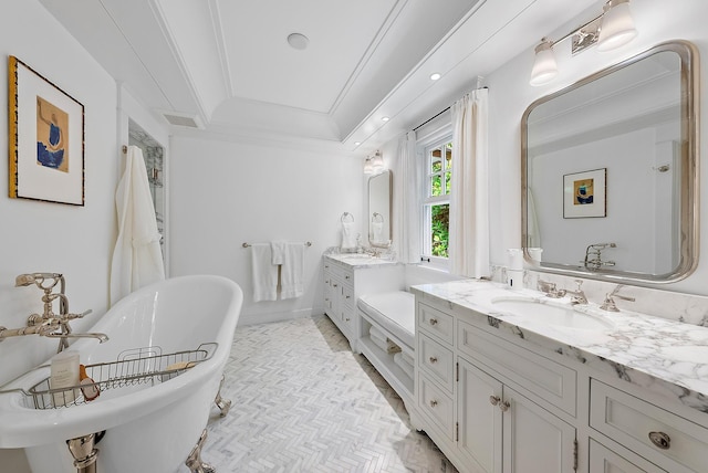 bathroom with vanity, a tub to relax in, and ornamental molding