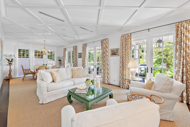 carpeted living room with plenty of natural light, french doors, and coffered ceiling