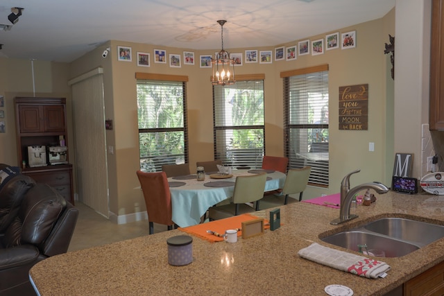 dining space featuring sink and a chandelier