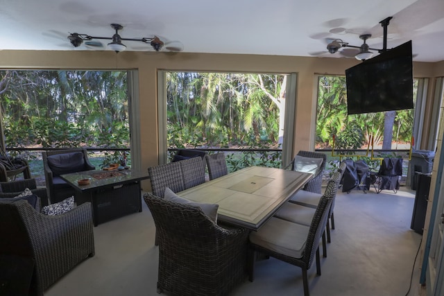 sunroom featuring ceiling fan