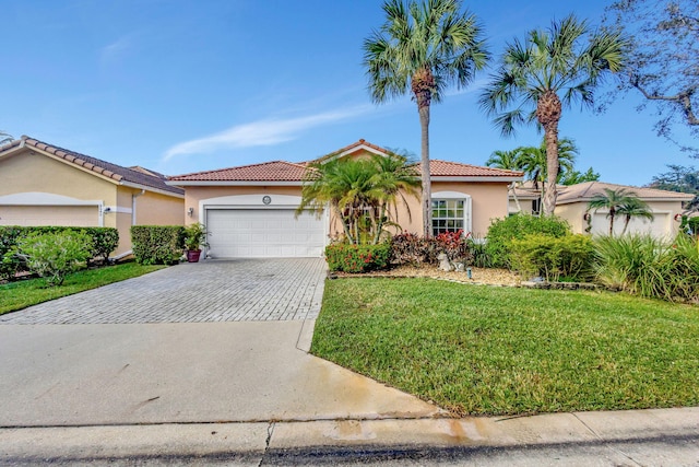 mediterranean / spanish-style house featuring a garage and a front lawn