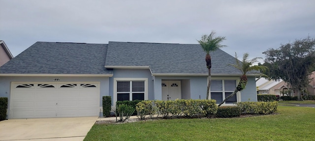 view of front of property featuring a shingled roof, a front yard, driveway, and an attached garage