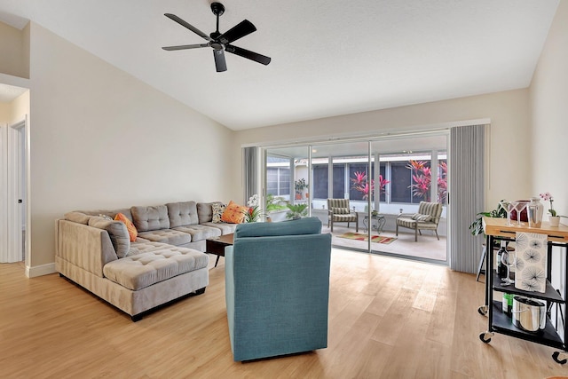 living area with vaulted ceiling, wood finished floors, and a ceiling fan