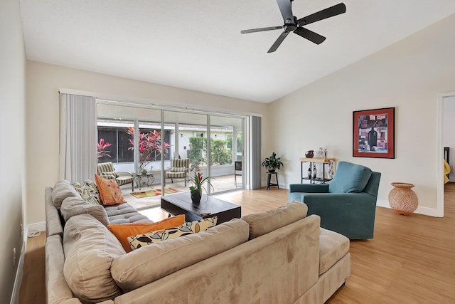 living area featuring light wood-style floors, lofted ceiling, ceiling fan, and baseboards