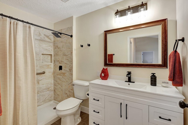 bathroom featuring a stall shower, toilet, a textured ceiling, and vanity