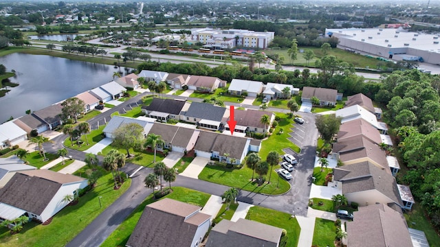 drone / aerial view with a water view and a residential view