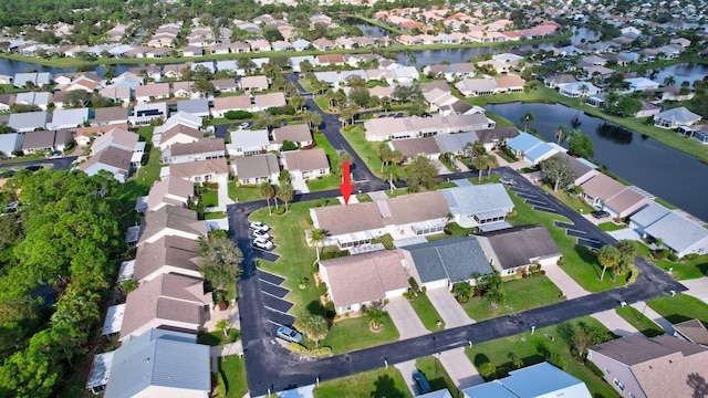 birds eye view of property with a water view and a residential view