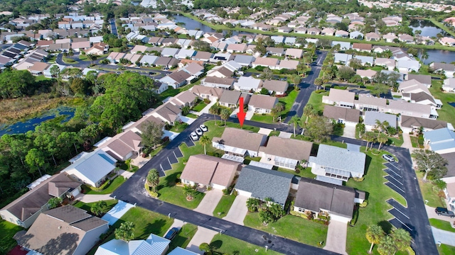 bird's eye view with a residential view and a water view