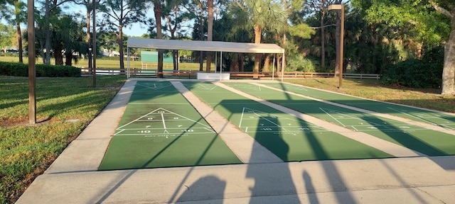 view of home's community featuring shuffleboard and a yard