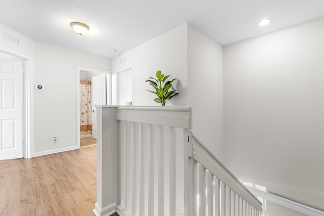 corridor with light hardwood / wood-style flooring