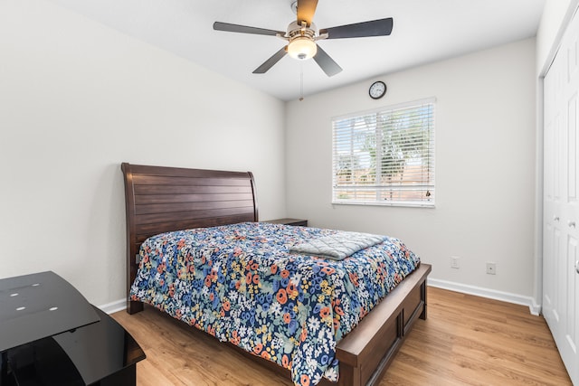 bedroom featuring ceiling fan, a closet, and light wood-type flooring