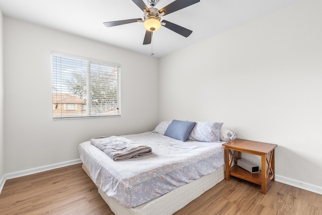 bedroom with hardwood / wood-style floors and ceiling fan