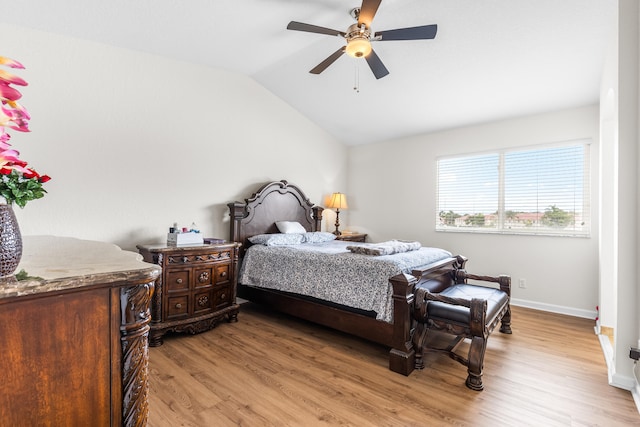 bedroom with light hardwood / wood-style flooring, ceiling fan, and lofted ceiling