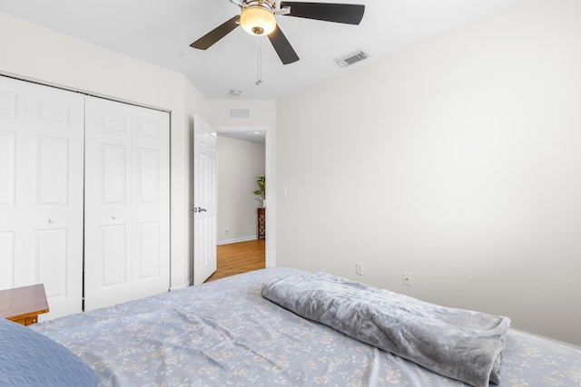 bedroom featuring ceiling fan and a closet