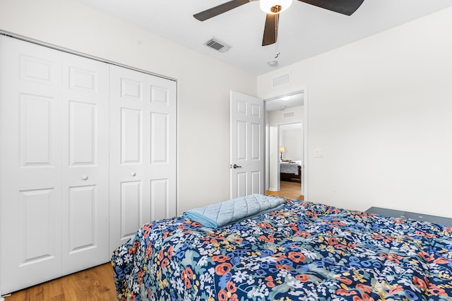 bedroom with a closet, ceiling fan, and hardwood / wood-style flooring