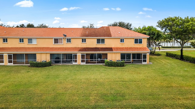 rear view of house with a yard