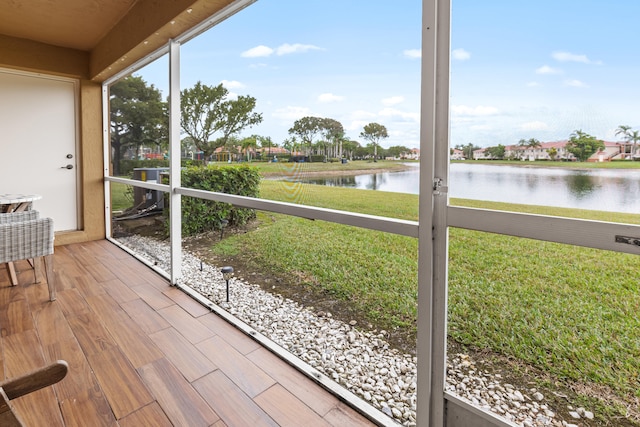 unfurnished sunroom with a water view