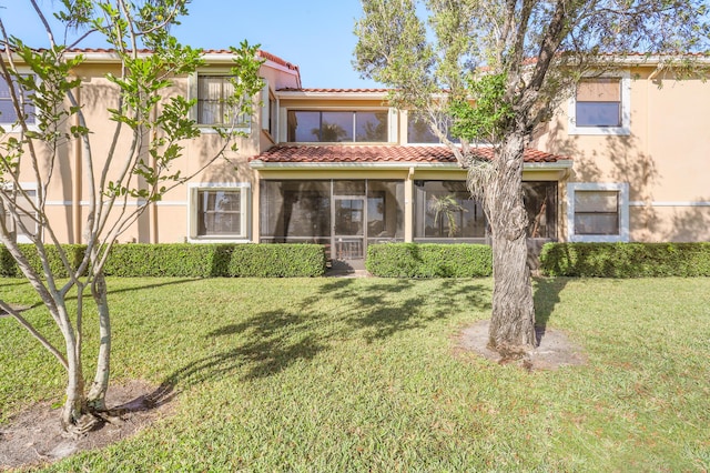 back of house with a lawn