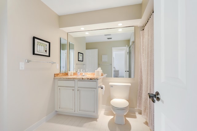 bathroom featuring tile patterned floors, vanity, and toilet