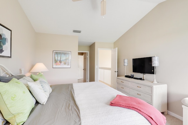 bedroom featuring light carpet and vaulted ceiling